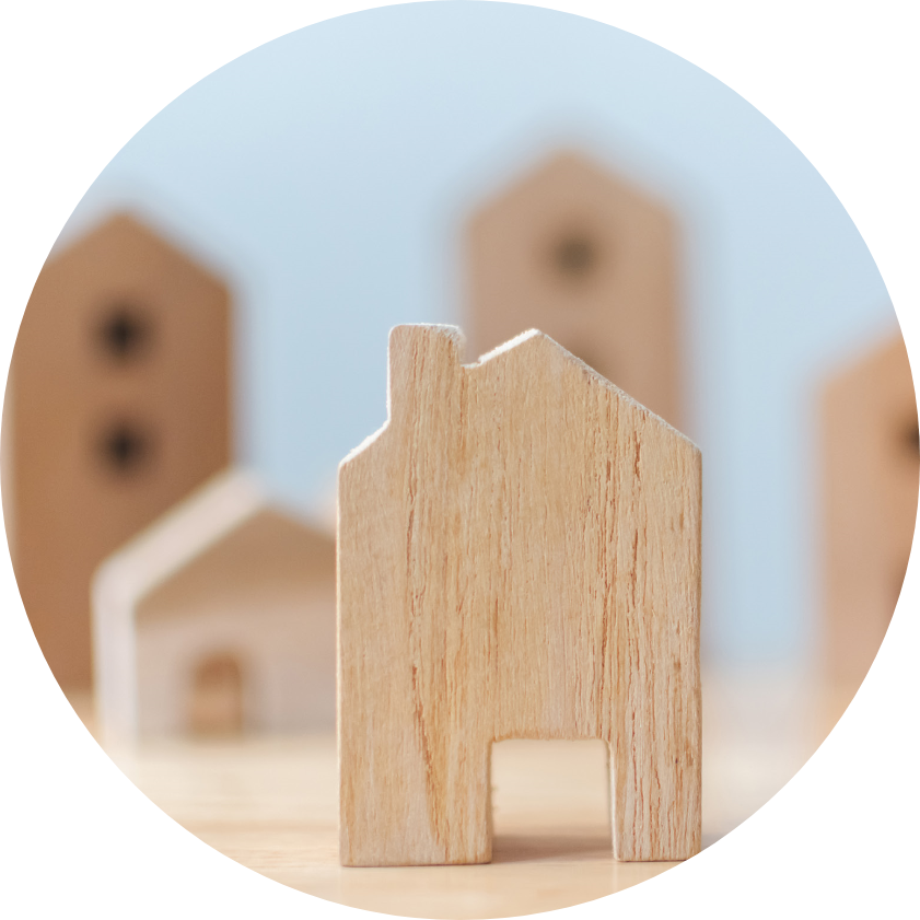 Symbolic image representing landlord investments - one wooden house front and other wooden houses in blurry background